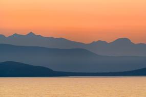 sunset over idyllic mountain landscapes in greece