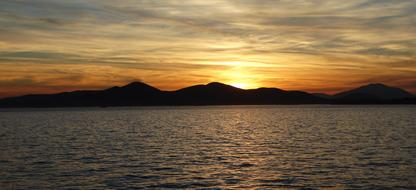 Sunset over mountains and sea