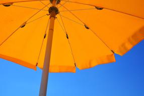 Yellow Parasol at blue sky, detail, low angle view