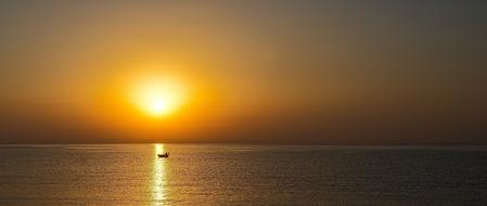 landscape of boat on sea at Sunset