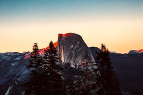 Beautiful landscape of the mountains with trees in Yosemite National Park, USA, at colorful and beautiful sunrise