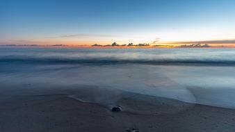 Beautiful landscape of the colorful coast of Denmark with plants, at colorful sunset