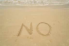 No on the beach sand near the surf