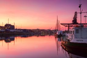 City harbor of Rostock, Germany, with ships, at colorful and beautiful sunset