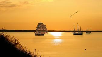 ship on Waters at Sunset