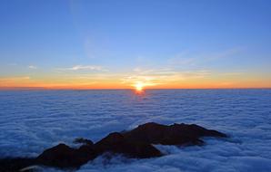 sunrise over fluffy white clouds