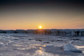 beach with snow near the sea in winter