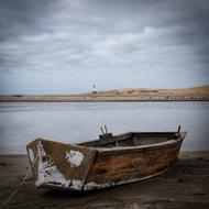 Beautiful landscape of the sea, with boat on the sandy shore