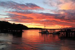 red sunset in the clouds over the harbor at dusk