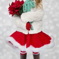 girl dressed as santa with a bouquet