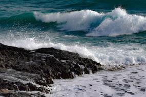 Surf, waves splashing on rocky beach