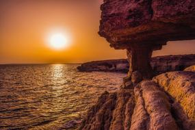 sea caves on the coast of cyprus at sunset
