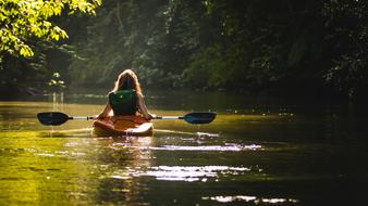 the girl floats on a canoe on the lake