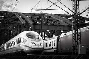 Black and white photo with trains under the Hohenzollern Bridge in Cologne, Germany