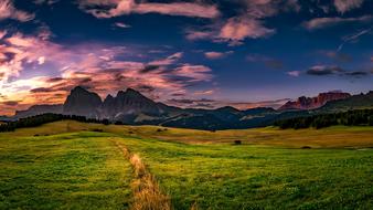 Beautiful and colorful landscape of the fields near the mountains in Italy, at colorful and beautiful sunset