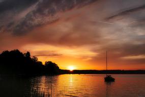 romantic sunset over the lake at dark twilight