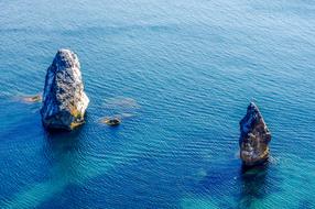 Beautiful and colorful rocks in the sea with ripple, in sunlight, near the Crimea