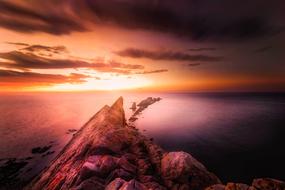 rocks against the backdrop of a colorful sunset in Spain