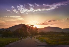 Beautiful landscape of the road among the plants, near the mountains in Korea, at colorful and beautiful sunset