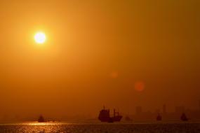 ships Silhouette on Ocean at Sunset