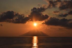 distant view of the small volcanic island of Stromboli at dusk