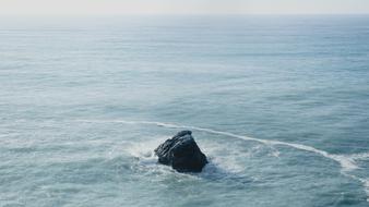 black rock in the tropical ocean