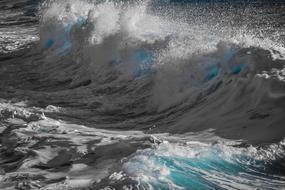 Close-up of the beautiful, shiny, turquoise and white waves in the water, in sunlight