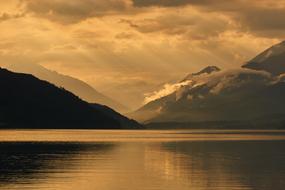 lake near the mountain with valleys at dusk