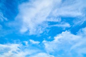 white clouds on blue sky with sunlight