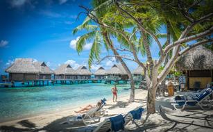 bungalows over turquoise water on bora bora