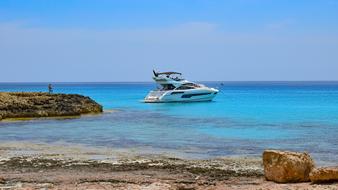 Yacht on the beautiful and colorful rocky coast in Ayia Napa, Cyprus, Greece