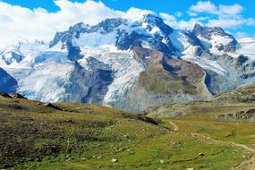 white clouds over picturesque mountains on a sunny day