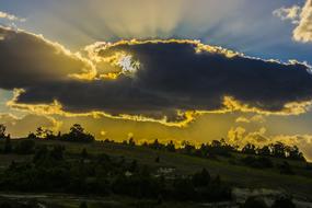 Beautiful landscape with the mountains with plants, at colorful and beautiful sunset in the clouds