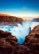 waterfall in a picturesque landscape of iceland