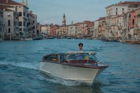 boat on the canal in venice at sunset