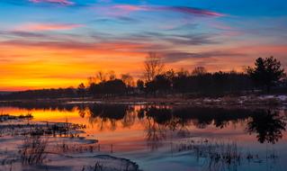 orange sunrise over the lake in winter