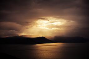 Beautiful landscape with silhouettes of the mountains, at beautiful sunset among the clouds