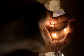 christmas lights in hand in the dark