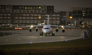 Aircraft at the airport of Frankfurt, Germany, with colorful lights, in the evening