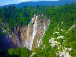 picturesque waterfall on green mountain