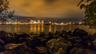 Beautiful landscape with the coast of Elbe, with rocks, plants and colorful lights, in Hamburg, Germany, under the clouds