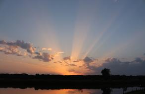 Beautiful landscape with the water with reflections, at beautiful and colorful sunset with clouds