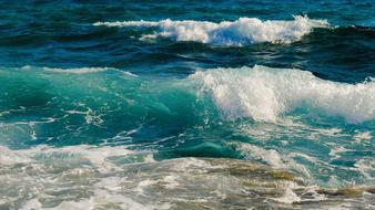 foam splashing turquoise waves on a sunny day