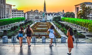 People near the colorful and beautiful flower carpet in Brussels, Belgium, at colorful and beautiful sunset