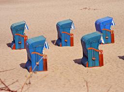blue beach chairs on the baltic sea coast