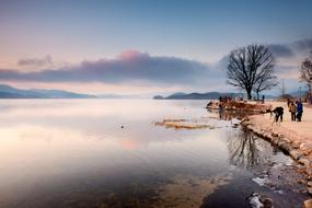 People on river bank at Dawn