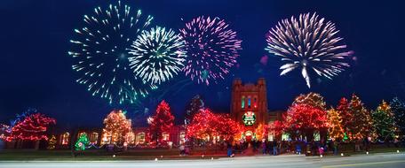 christmas lights on dark night sky over colorful city