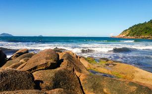 rocky Beach at blue sea beneath clear sky, caribbean