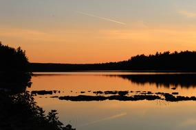 orange twilight mirrored in calm water