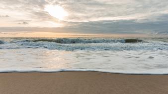 surf on the beach in denmark at dusk
